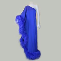 One-shoulder feather Dress, Evening dress with large sleeves, Stunning style decorated with feather Trim for a statement look. DETAILS: - Royal Blue 1575 - Duchess Fabric - Aissha Satin Lining - Ostrich feather - Asymmetric design - Off-shoulder - Feather-trim detailing - Concealed zip fastening - Ankle-length COMPOSITION: Ostrich Feather 100%, Polyester 100% CARE INSTRUCTIONS: Dry clean only and be careful not to let water get on the fur. SIZE&FIT: - Fits true to size, take your normal size - D One-shoulder Feather Dress For Evening, One-shoulder Feathered Evening Dress, One Shoulder Feather Dress For Evening, One Shoulder Evening Dress With Feathers, Blue Feather Evening Dress, Blue Feathered Evening Dress, Duchess Fabric, Fur Dress, Stunning Style