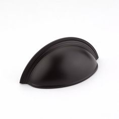 a black plastic object on a white surface