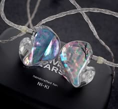 the earphones have iridescent colors and are plugged in with wires attached to them