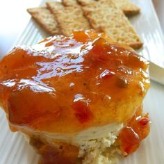 a close up of a sandwich on a plate with crackers and ketchup