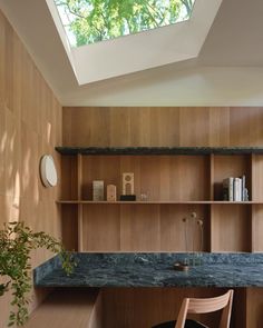 a room with wooden shelves and a skylight