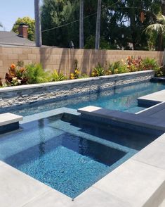 an outdoor swimming pool with concrete steps leading up to it