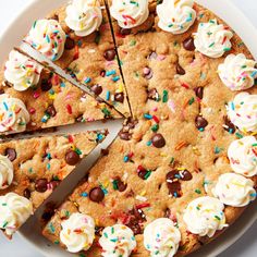 a cookie cake with white frosting and sprinkles