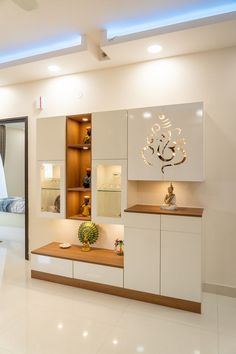 a modern living room with white walls and flooring, including an entertainment center on the far wall