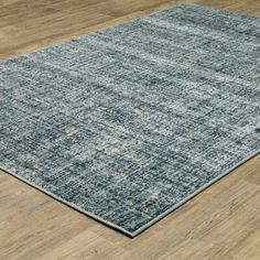 an area rug on the floor with wooden floors and hard - wearing wood planks