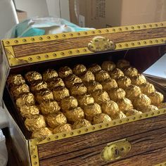 a wooden box filled with gold foiled chocolates