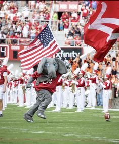 an elephant mascot running on the football field