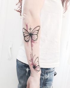 a woman with a butterfly tattoo on her arm