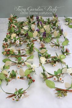 flowers and leaves are laid out on a white tablecloth with the words fairy garden party written above them