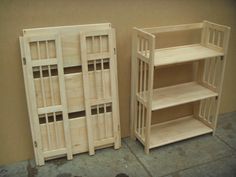 two wooden shelves sitting next to each other on top of a cement floor in front of a wall