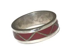 a red and silver ring on a white background