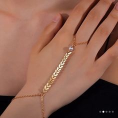 This Beautiful Hand Chain Ring Bracelet Is Perfect For Any Fashion-Forward Woman. The Dainty Pearl Leaf Design Adds A Touch Of Elegance To Any Outfit, While The Gold Color Gives It A Luxurious Feel. The Bracelet Is Crafted From High-Quality Materials, Ensuring It Will Last For Years To Come. The Ring Bracelet Is Designed To Fit Comfortably On Any Finger, Making It A Versatile Accessory That Can Be Worn With Any Outfit. The Shape Of The Leaf Is A Gorgeous Addition To The Piece, Adding A Touch Of Chain Ring Bracelet, Finger Ring Bracelet, Ring Bracelet Chain, The Leaf, Hand Chain, Finger Ring, Ring Finger, Bracelet Gold, Chain Ring