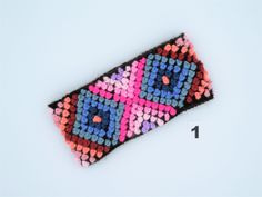 a crocheted case is shown with the number one on it's side