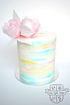 there is a colorful cake with flowers on top