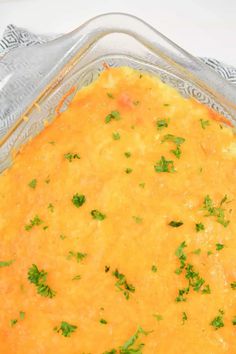 a cheesy casserole dish with parsley on top