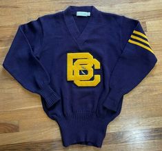 Vintage 60's Boston College BC Track & Field Wool Sweater Sz 42 Burean-Holloway. Features metal winged shoe on BC logo In great vintage condition, no stains or flaws. Some slight wear at top of sleeves seen in final images. Measurements: Approximate Length: 28" Pit to pit: 20 1/4" Sleeve (uncuffed): 24" The measurements are taken in inches with the item laying flat. If you’re uncertain of the way an item may fit, measure a well fitting item of yours to compare these measurements with before purc College Sweater Aesthetic, College Track, Bc Logo, College Clothes, Baseball Fashion, College Sweater, Vintage Boston, Boston College, Athletic Club