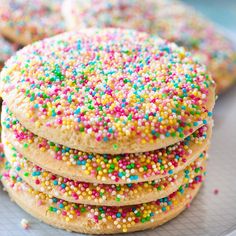 a stack of sprinkle covered cookies on a plate