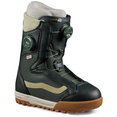 the snowboard boots are black and tan with green buttons on each side of the boot