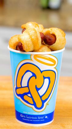 a blue cup filled with food on top of a wooden table