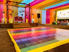 a colorful dance floor is in the middle of a room