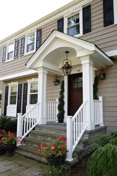 a house with white pillars and black shutters