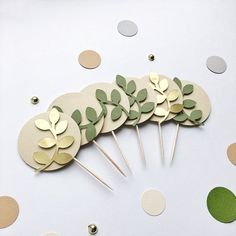 a group of cake toppers sitting on top of a table next to confetti