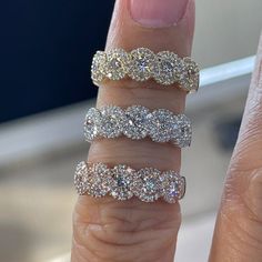 a woman's hand with three different rings on it