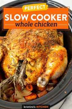 a whole chicken in a slow cooker with carrots and onions