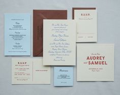 the wedding stationery is laid out on top of each other