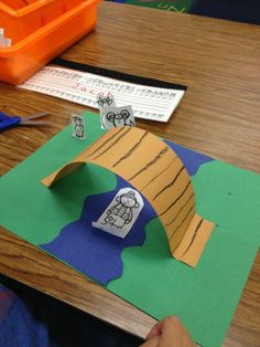 someone is making a paper house on the table