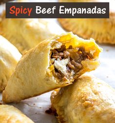 some food that is sitting on top of a piece of paper with the words spicy beef empanadas in it