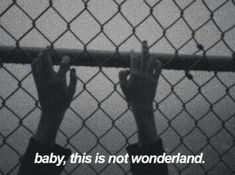 two hands holding up a fence with the words baby, this is not wonderlandland