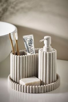 a toothbrush holder with soap and money in it