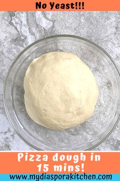 a round dough in a glass bowl on a marble counter