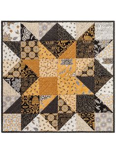 a yellow and black patchwork quilt with an intricate design on the front, in different colors