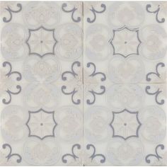 two white and gray tiles with designs on them