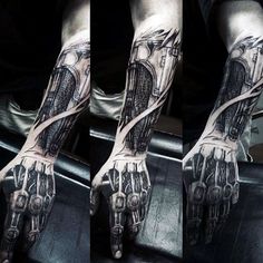 a man's arm and hand covered in black ink with an image of a motorcycle