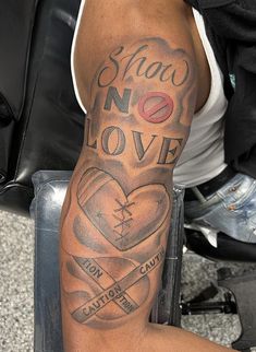 a man with a tattoo on his arm that says shaw no love and two hearts