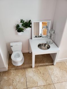 a bathroom with a sink, toilet and mirror on the wall next to each other