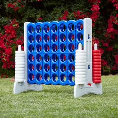 two giant blue and red game pieces in the grass