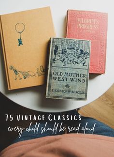 three vintage books sitting on top of a white plate