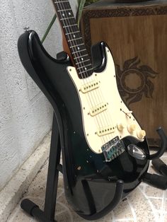 an electric guitar sitting on top of a stand