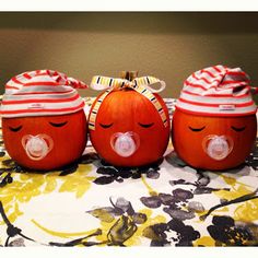 three pumpkins with faces painted on them