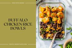 buffalo chicken rice bowls with black beans and green onions in a glass dish on a marble countertop