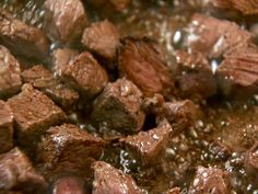 closeup of beef and brown sauce cooking in a pan