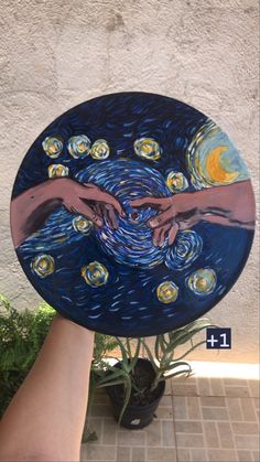 a plate with two hands reaching for the starry night painting on it's side