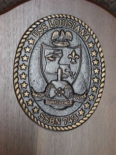 this is the seal for uss louis ma on a wooden plaque that reads uss louis ma