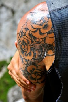 a man with a flower tattoo on his shoulder