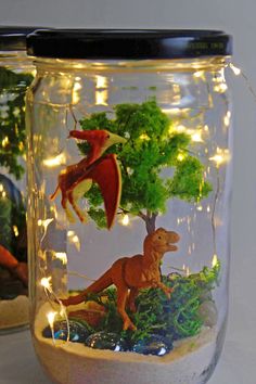 a jar filled with plastic dinosaurs and lights