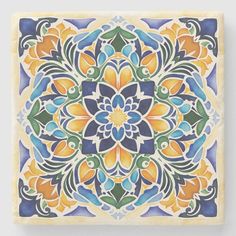 an artistic tile design in blue, yellow and green colors on a white wall or floor